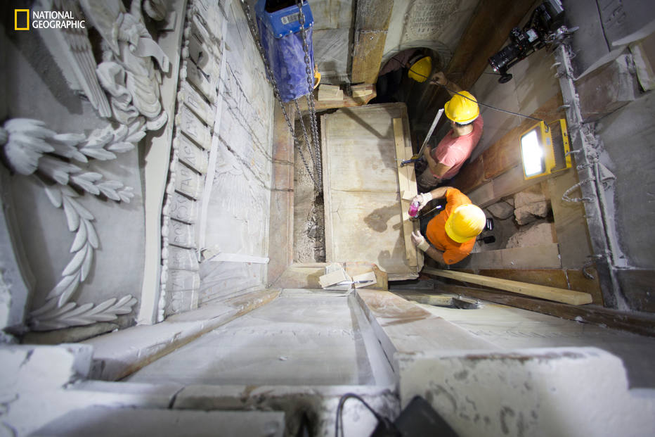 This Wednesday Oct. 26, 2016 photo, shows the moment workers remove the top marble layer of the tomb said to be of Jesus Christ, in the Church of Holy Sepulcher in Jerusalem. A restoration team has peeled away a marble layer for the first time in centuries in an effort to reach what it believes is the original rock surface where Jesus' body was laid. (Dusan Vranic/National Geographic via AP)